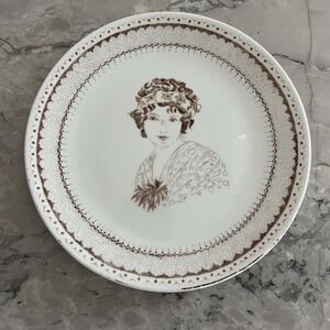 Handpainted 9.5" plate featuring woman signed "S. Bailey"